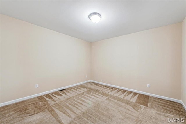 carpeted empty room with baseboards
