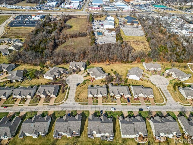 aerial view of property and surrounding area with nearby suburban area