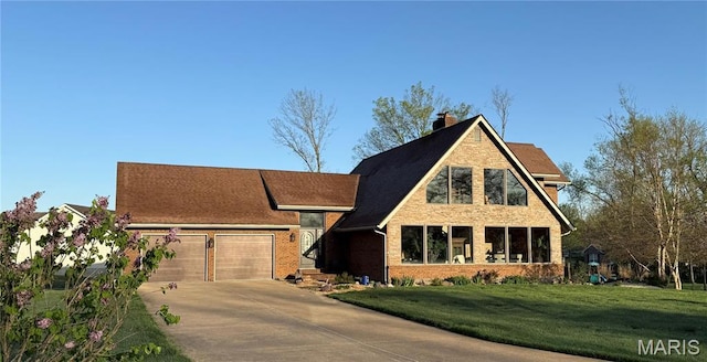 717 Ozark Dr, Farmington, MO 63640 - view of front of home with driveway, an attached garage, a front lawn, a chimney, and brick siding