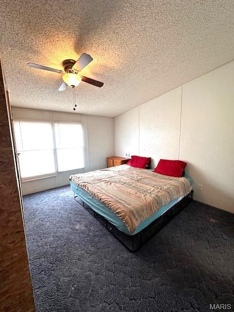 16625 Scott Ln, Willow Springs, MO 65793 - bedroom featuring carpet flooring, a textured ceiling, and a ceiling fan