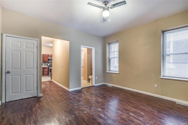 3018 Texas Ave, Saint Louis, MO 63118 - spare room featuring ceiling fan, dark wood-style flooring, and plenty of natural light