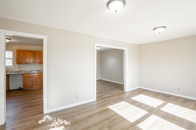 20 W Broadway, Ellsinore, MO 63937 - spare room with light wood-style floors and baseboards