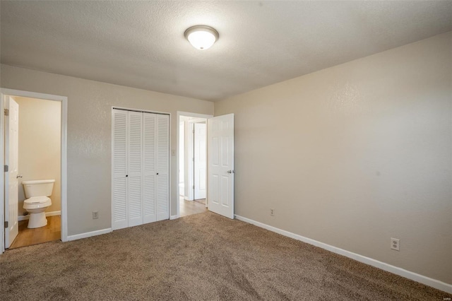 20 W Broadway, Ellsinore, MO 63937 - unfurnished bedroom featuring carpet flooring, a closet, connected bathroom, and baseboards
