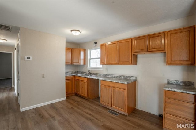20 W Broadway, Ellsinore, MO 63937 - kitchen with wood finished floors and brown cabinetry