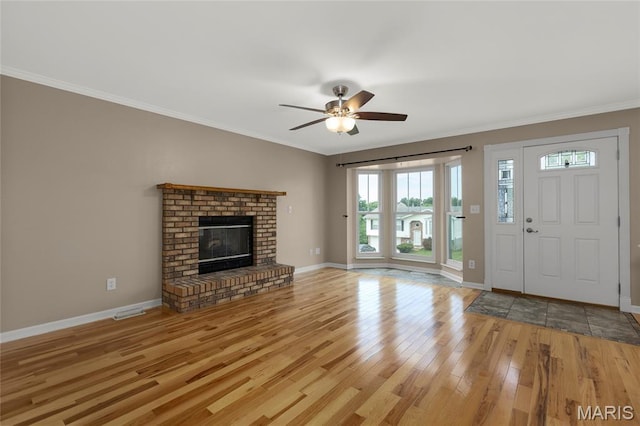 4012 Sunny Brook Dr, Arnold, MO 63010 - unfurnished living room featuring wood finished floors, healthy amount of natural light, ornamental molding, ceiling fan, and a fireplace
