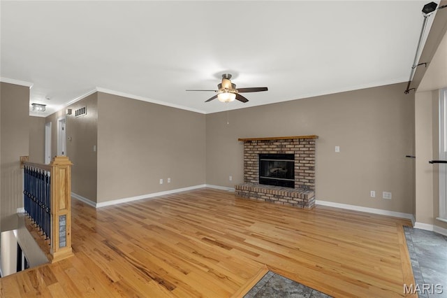 4012 Sunny Brook Dr, Arnold, MO 63010 - unfurnished living room featuring wood finished floors, a ceiling fan, ornamental molding, and a brick fireplace