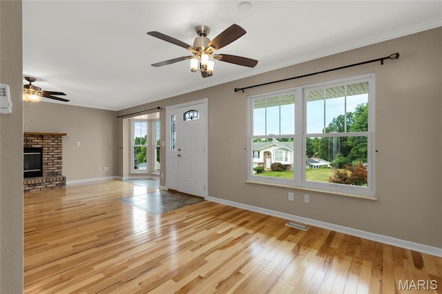 4012 Sunny Brook Dr, Arnold, MO 63010 - entrance foyer featuring ceiling fan, hardwood / wood-style flooring, crown molding, and a brick fireplace