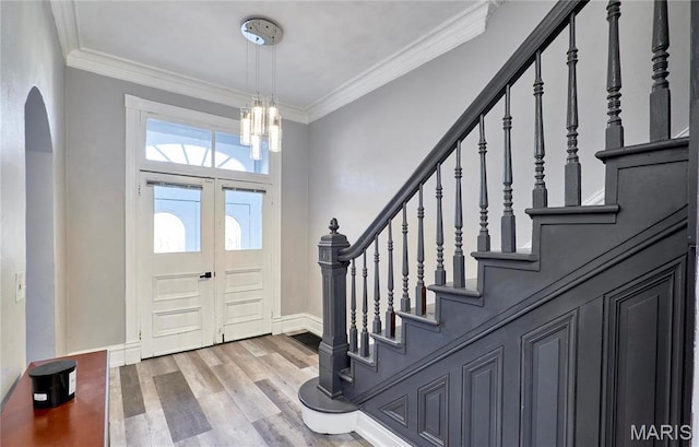 2922 S Compton Ave, Saint Louis, MO 63118 - entrance foyer with wood finished floors, a chandelier, crown molding, stairway, and baseboards