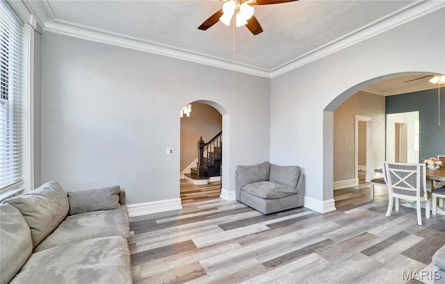 2922 S Compton Ave, Saint Louis, MO 63118 - living area featuring a ceiling fan, wood finished floors, crown molding, baseboards, and stairway