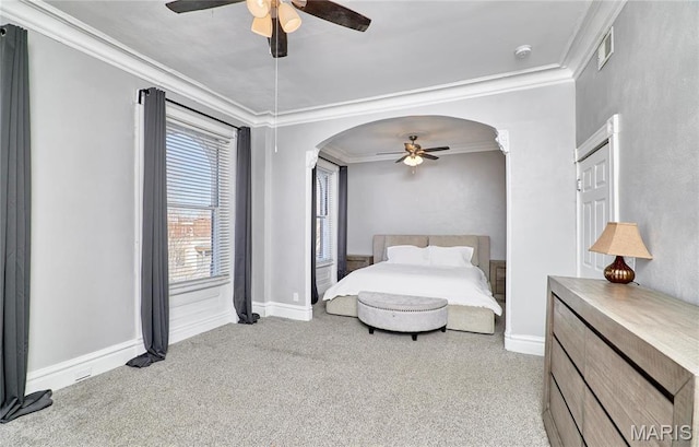 2922 S Compton Ave, Saint Louis, MO 63118 - bedroom featuring arched walkways, carpet floors, ornamental molding, a ceiling fan, and baseboards
