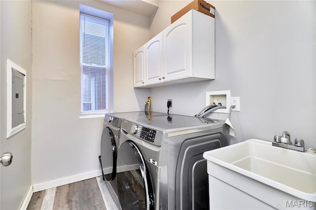 2922 S Compton Ave, Saint Louis, MO 63118 - laundry room featuring cabinet space, separate washer and dryer, wood finished floors, baseboards, and electric panel