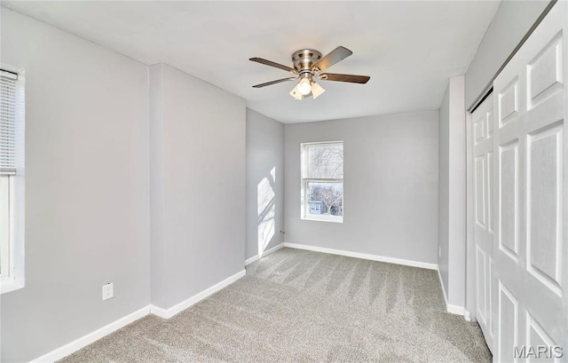 2922 S Compton Ave, Saint Louis, MO 63118 - unfurnished bedroom with carpet floors, baseboards, a ceiling fan, and a closet