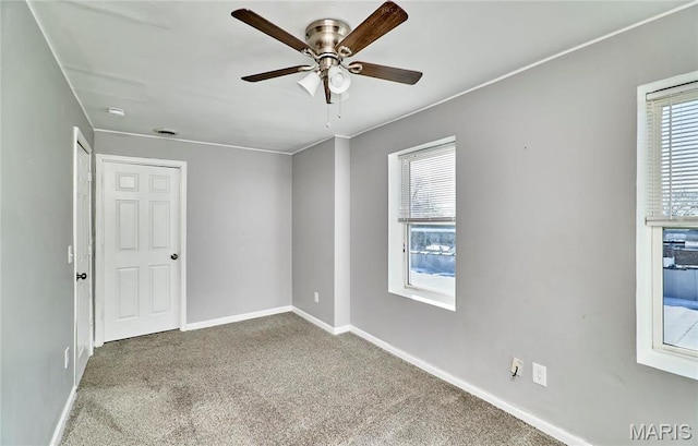2922 S Compton Ave, Saint Louis, MO 63118 - unfurnished room featuring ceiling fan, healthy amount of natural light, carpet flooring, and baseboards