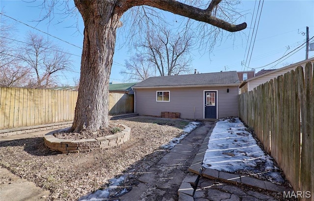 2922 S Compton Ave, Saint Louis, MO 63118 - back of house with a fenced backyard and an outbuilding