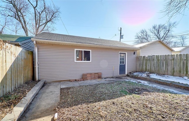 2922 S Compton Ave, Saint Louis, MO 63118 - rear view of property featuring a fenced backyard and a shingled roof