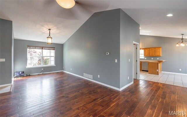 16855 Lemming Ln, Saint Robert, MO 65584 - unfurnished living room featuring lofted ceiling, light wood-type flooring, a chandelier, baseboards, and recessed lighting