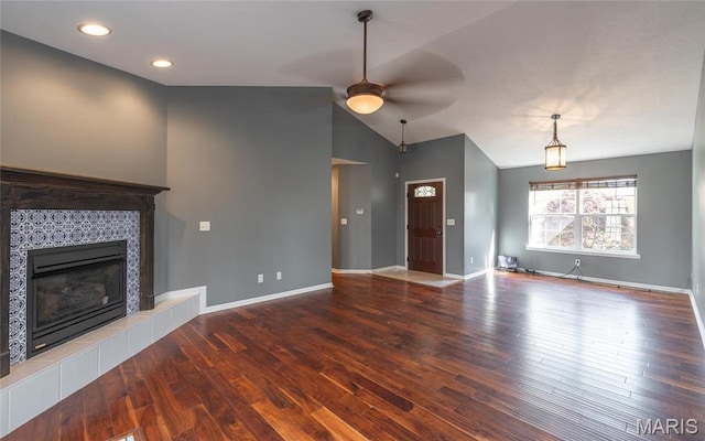 16855 Lemming Ln, Saint Robert, MO 65584 - unfurnished living room featuring ceiling fan, a tile fireplace, lofted ceiling, wood finished floors, and baseboards