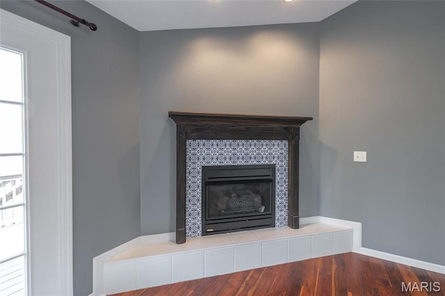 16855 Lemming Ln, Saint Robert, MO 65584 - detailed view of wood finished floors, a tile fireplace, and baseboards