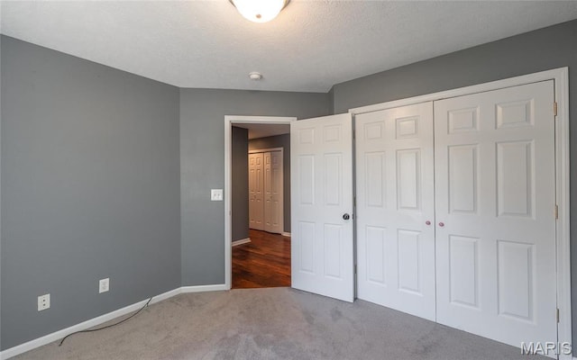16855 Lemming Ln, Saint Robert, MO 65584 - unfurnished bedroom with baseboards, a closet, carpet, and a textured ceiling