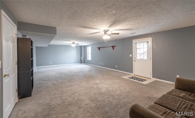 16855 Lemming Ln, Saint Robert, MO 65584 - unfurnished living room with ceiling fan, baseboards, carpet floors, and a textured ceiling