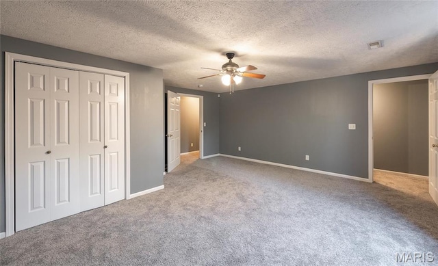 16855 Lemming Ln, Saint Robert, MO 65584 - unfurnished bedroom with carpet flooring, a closet, baseboards, ceiling fan, and a textured ceiling