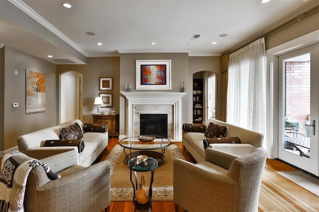 155 Carondelet Plz Unit 600, Saint Louis, MO 63105 - living room with arched walkways, wood finished floors, crown molding, a fireplace, and recessed lighting