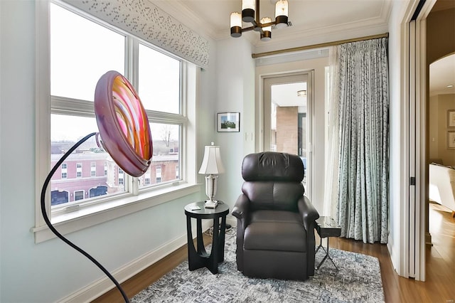 155 Carondelet Plz Unit 600, Saint Louis, MO 63105 - living area with a chandelier, wood finished floors, crown molding, and baseboards