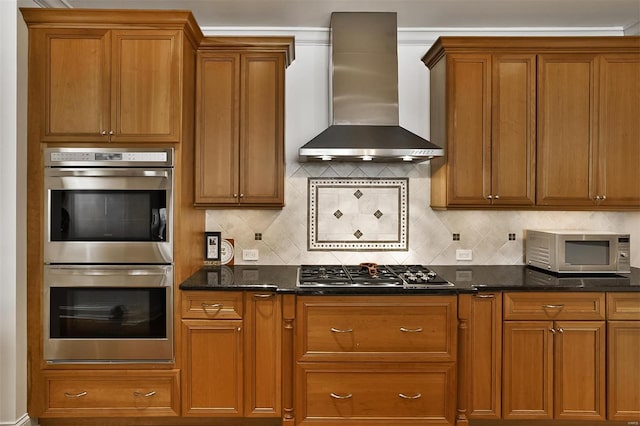 155 Carondelet Plz Unit 600, Saint Louis, MO 63105 - kitchen with appliances with stainless steel finishes, wall chimney range hood, brown cabinetry, and decorative backsplash