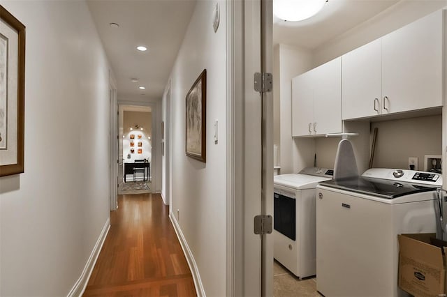 155 Carondelet Plz Unit 600, Saint Louis, MO 63105 - laundry room featuring cabinet space, separate washer and dryer, light wood finished floors, recessed lighting, and baseboards