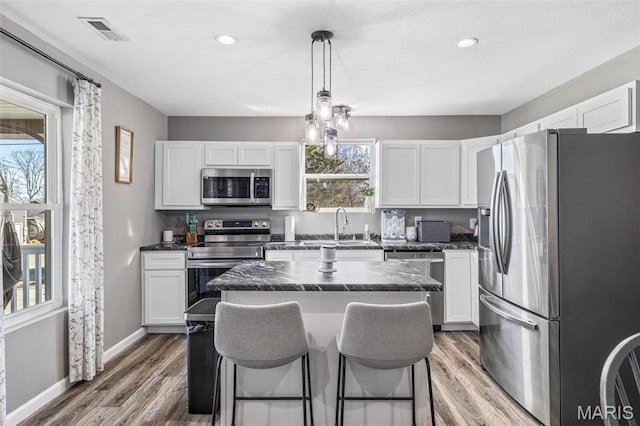 419 Murrill St, Bonne Terre, MO 63628 - kitchen featuring stainless steel appliances, a kitchen island, white cabinets, and recessed lighting