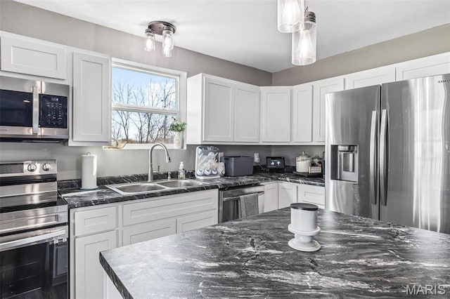 419 Murrill St, Bonne Terre, MO 63628 - kitchen with stainless steel appliances, a sink, white cabinetry, and dark stone countertops