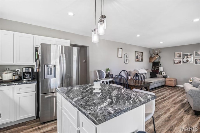 419 Murrill St, Bonne Terre, MO 63628 - kitchen with stainless steel fridge, open floor plan, dark wood-style floors, a kitchen breakfast bar, and white cabinetry