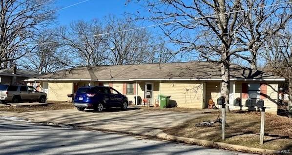ranch-style house with concrete driveway