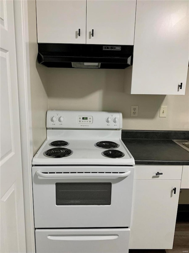 kitchen featuring white electric range, under cabinet range hood, white cabinets, and dark countertops