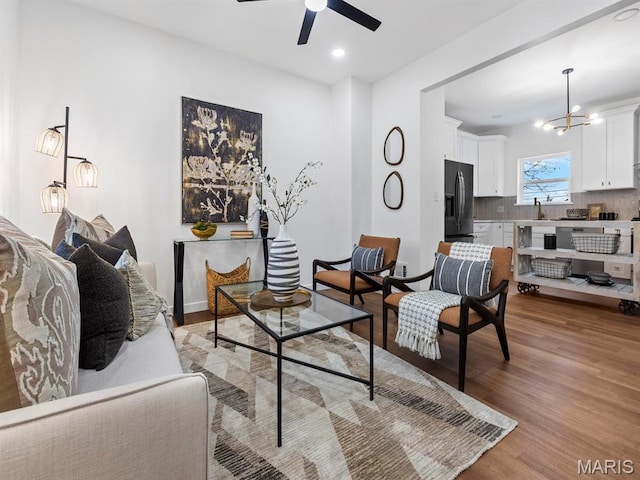 6634 Chamberlain Ave, University City, MO 63130 - living room featuring light wood-type flooring, a chandelier, a ceiling fan, recessed lighting, and baseboards