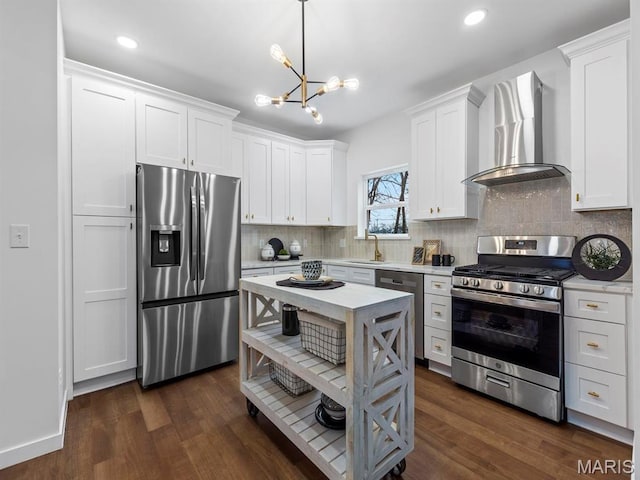6634 Chamberlain Ave, University City, MO 63130 - kitchen with appliances with stainless steel finishes, wall chimney exhaust hood, a chandelier, white cabinets, and recessed lighting