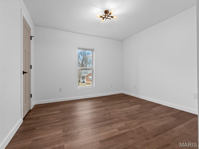 6634 Chamberlain Ave, University City, MO 63130 - empty room with wood finished floors, baseboards, and a chandelier