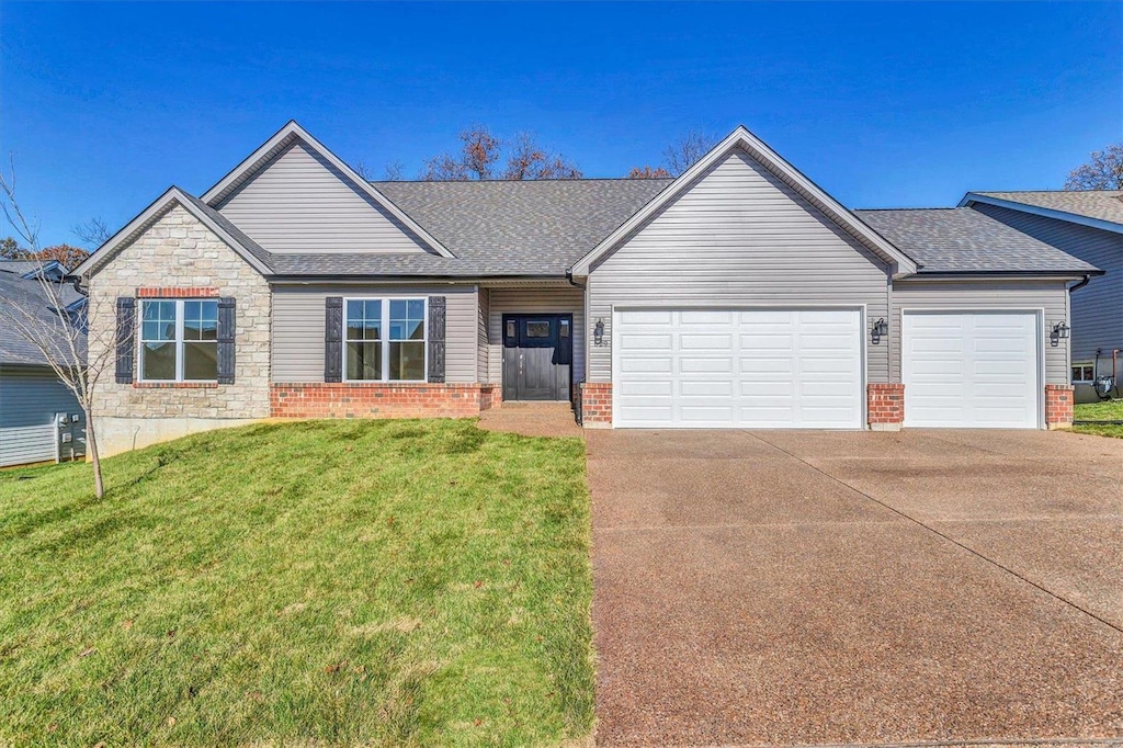 629 Castle Ridge Dr, Wentzville, MO 63385 - view of front of house featuring an attached garage, driveway, brick siding, a front yard, and a shingled roof
