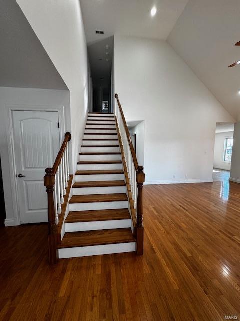 100 Walnut Ct, Saint Robert, MO 65584 - stairs with wood finished floors, high vaulted ceiling, baseboards, a ceiling fan, and recessed lighting