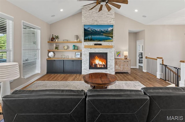 3837 Tanzanite Trl, Edwardsville, IL 62025 - living area featuring ceiling fan, vaulted ceiling, wood finished floors, a stone fireplace, and baseboards
