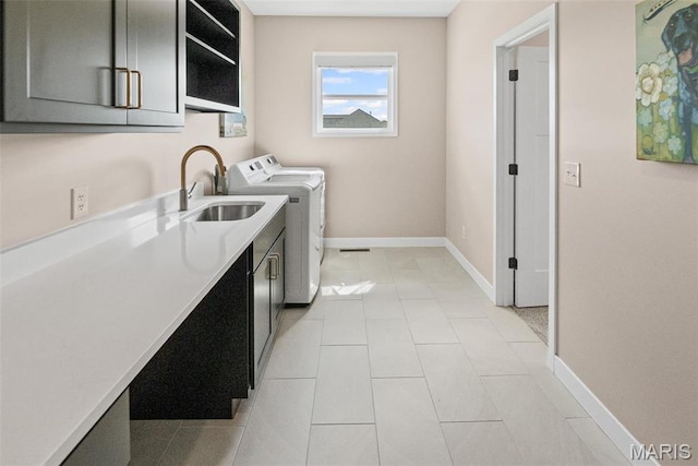 3837 Tanzanite Trl, Edwardsville, IL 62025 - laundry room with cabinet space, independent washer and dryer, baseboards, and light tile patterned floors