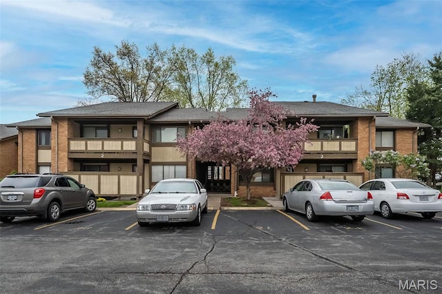 view of property featuring uncovered parking
