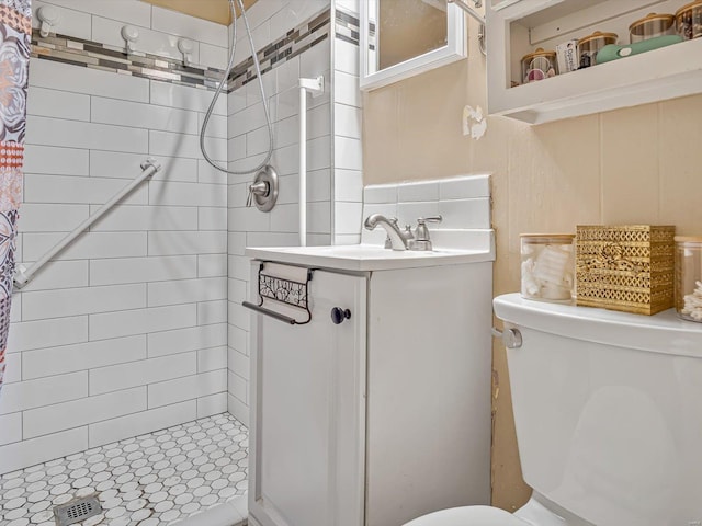 full bathroom with a shower stall, toilet, and vanity