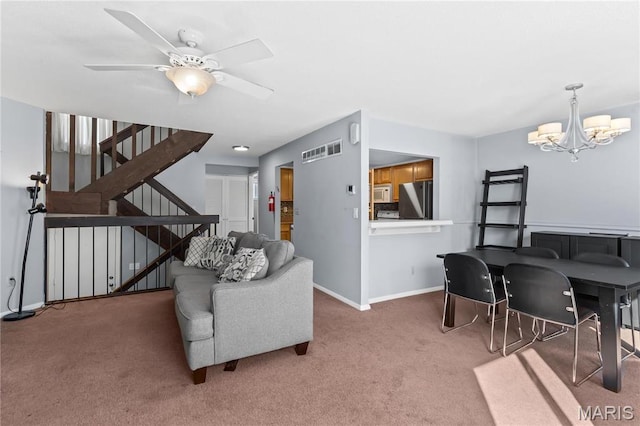 858 Lionsgate Dr, Saint Louis, MO 63130 - living room with carpet flooring, a chandelier, baseboards, stairs, and a ceiling fan