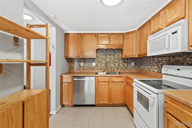 858 Lionsgate Dr, Saint Louis, MO 63130 - kitchen with white appliances, a sink, tasteful backsplash, light tile patterned flooring, and light countertops