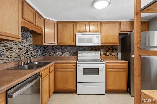 858 Lionsgate Dr, Saint Louis, MO 63130 - kitchen featuring white appliances, a sink, backsplash, light tile patterned floors, and light countertops