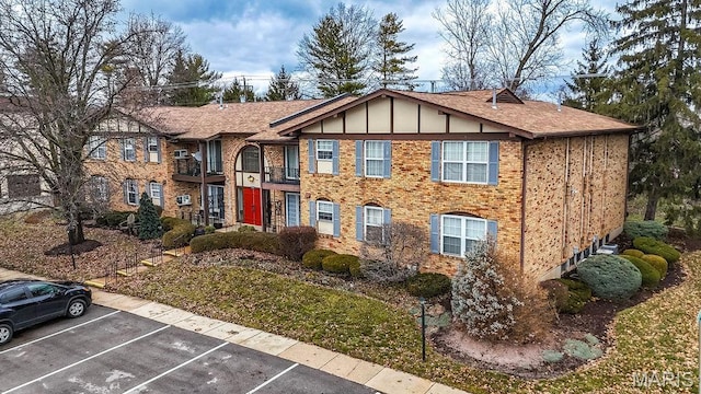 11741 Casa Grande Dr Unit G, Creve Coeur Township, MO 63146 - view of front of home with uncovered parking, a shingled roof, brick siding, and board and batten siding
