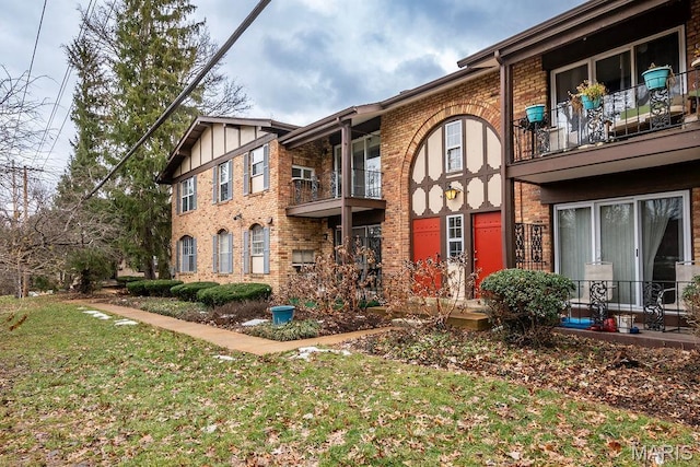 11741 Casa Grande Dr Unit G, Creve Coeur Township, MO 63146 - view of front facade with a balcony, a front yard, and brick siding