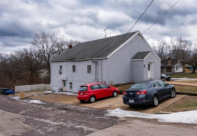 670 S Main St, Saint Clair, MO 63077 - view of side of home featuring a shingled roof and a chimney