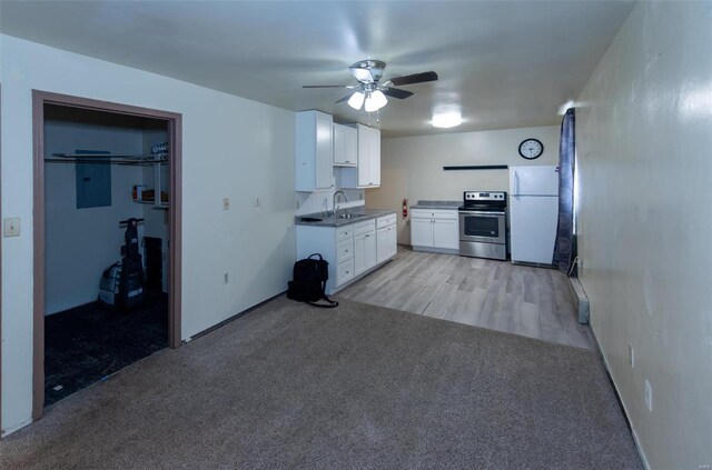 670 S Main St, Saint Clair, MO 63077 - kitchen featuring electric stove, freestanding refrigerator, a sink, ceiling fan, and white cabinets